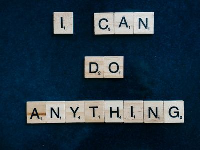 Person doing tree pose against a white wall